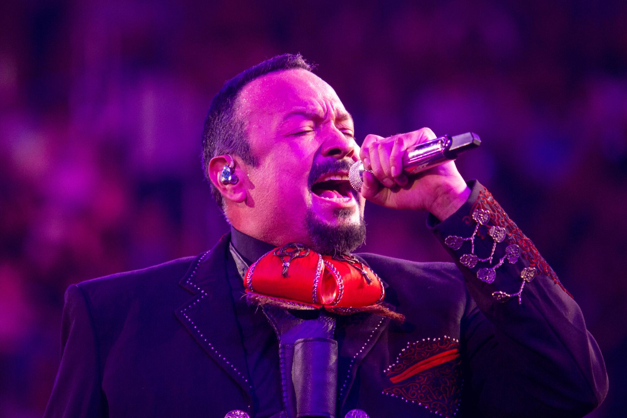 Pepe Aguilar performs under stage lights