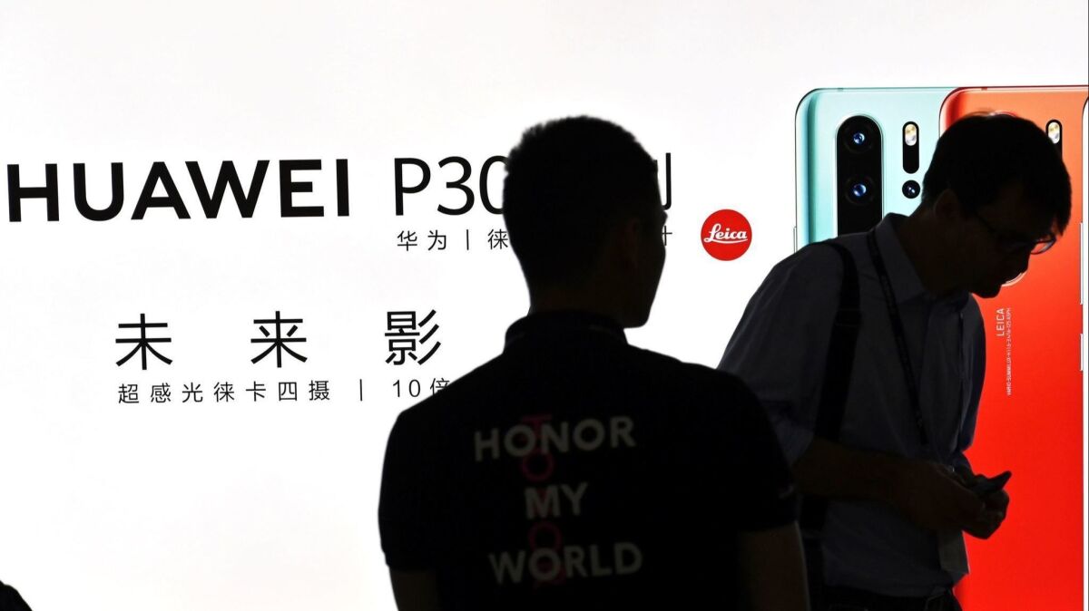 People visit a Huawei stand during the Mobile World Congress (MWC 2019) at the Shanghai New International Expo Centre(SNIEC) in Shanghai on June 26.