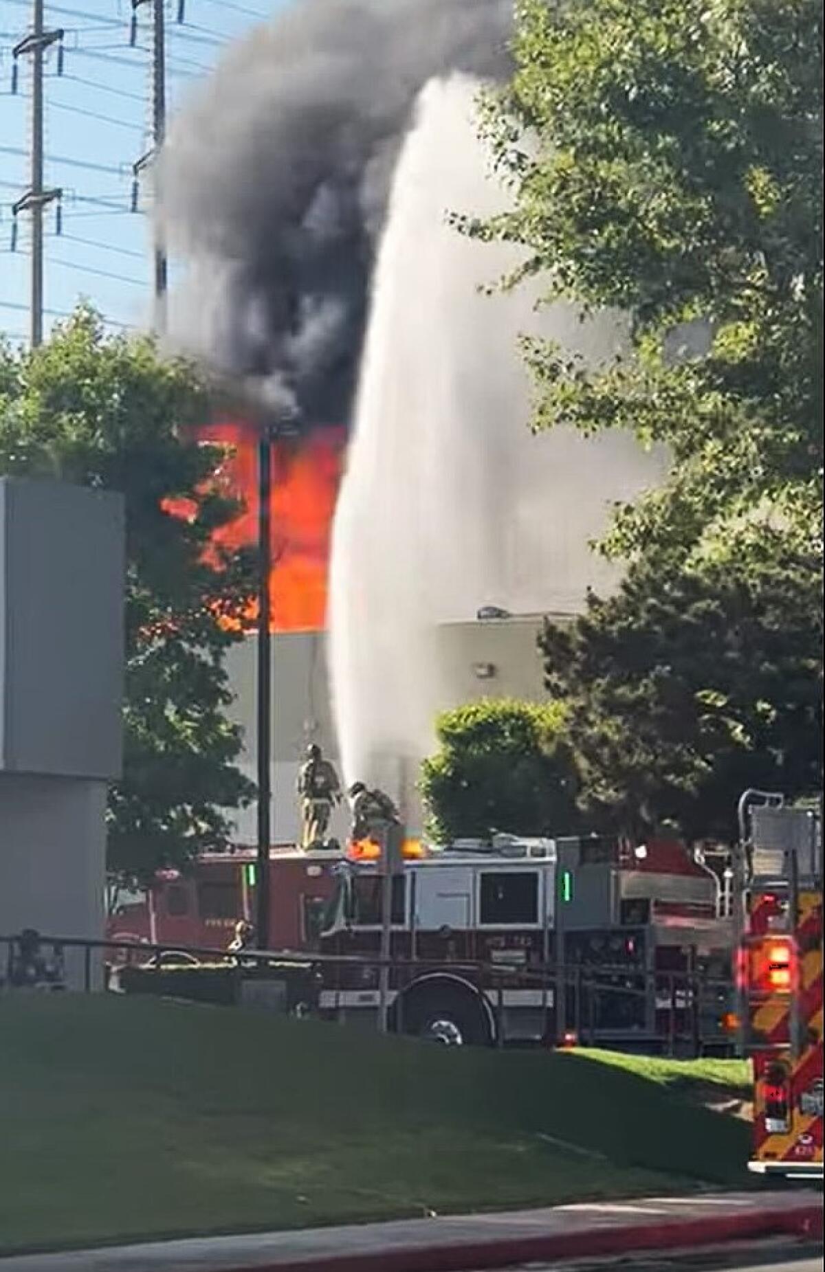 Costa Mesa fire crews battle a blaze that broke out at an industrial building on Cadillac Avenue.
