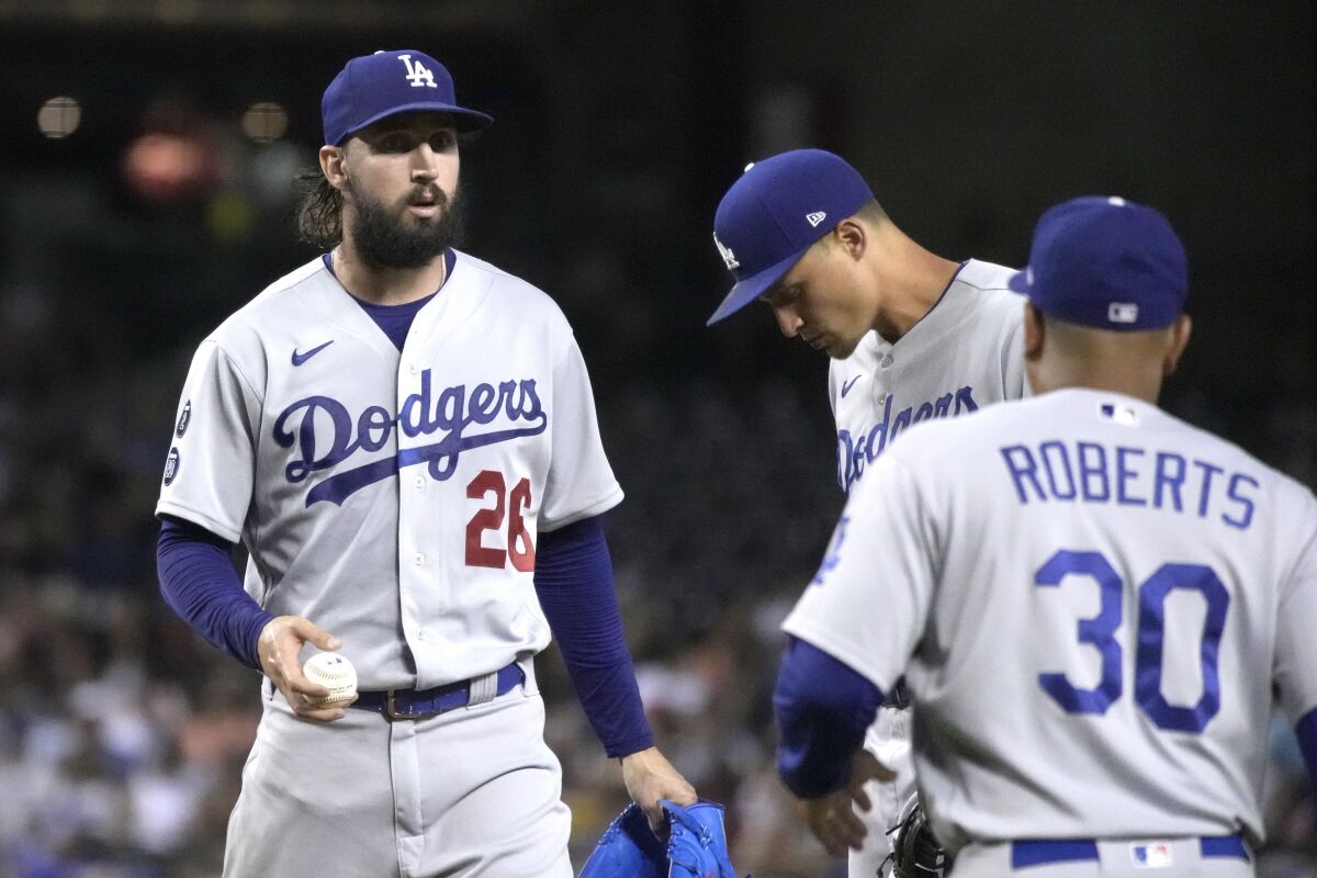 Dodgers pitcher Tony Gonsolin (26) is removed by manager Dave Roberts during the second inning July 30, 2021, in Phoenix.