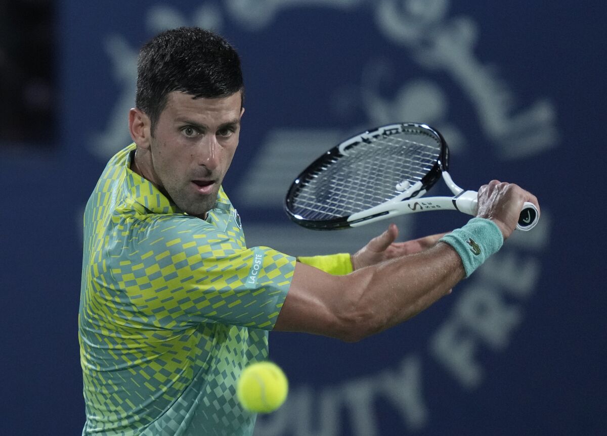 Serbia's Novak Djokovic returns the ball to Daniil Medvedev at the Dubai Duty Free Tennis Championships.