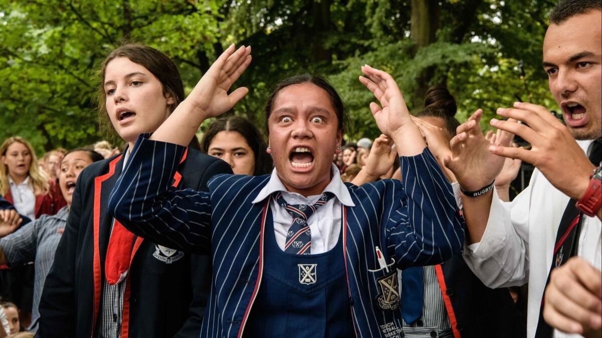 Students perform the haka during a vigil in Christchurch on Monday in honor of the 50 people killed in an attack on two mosques.