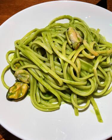 Green-sauced pasta studded with out-of-shell mussels from ?tra restaurant in Melrose Hill.