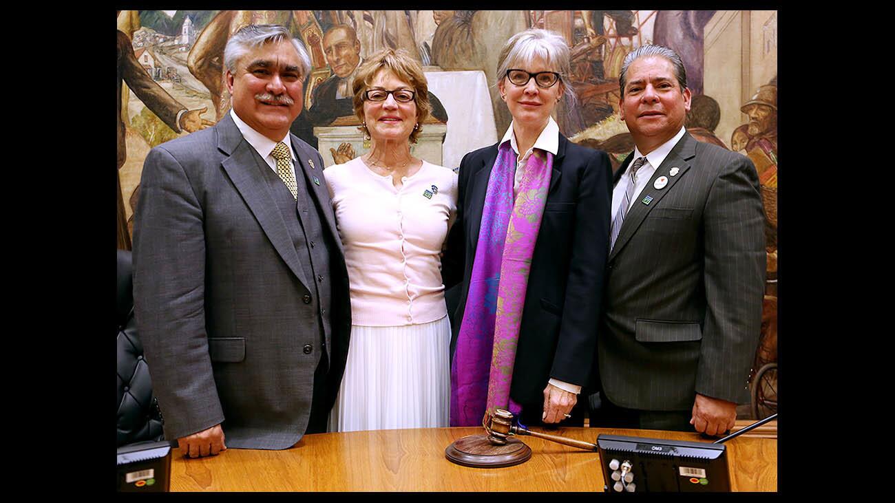Newly selected mayor Emily Gabel-Luddy, second from right, stands with newly selected vice mayor Sharon Springer, second from left, along with council members Jess Talamantes, left, and Bob Frutos, right, at the end of city council meeting on Tuesday, May 1, 2018. Most recent mayor Will Rogers died recently from complications of liver cancer, at age 60. His widow was honored by the city council.