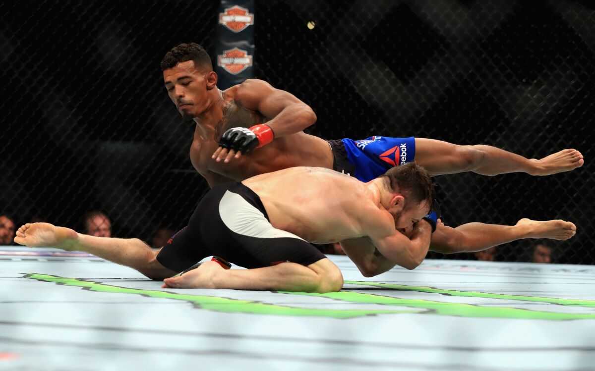 Jerrod Brooks (bottom) goes for the takedown against Eric Shelton during their flyweight bout at UFC 214.