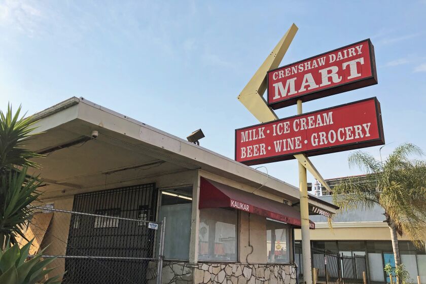 A 1960s-style mini mart has a red sign that reads "Crenshaw Dairy Mart" and a yellow Googie boomerang motif