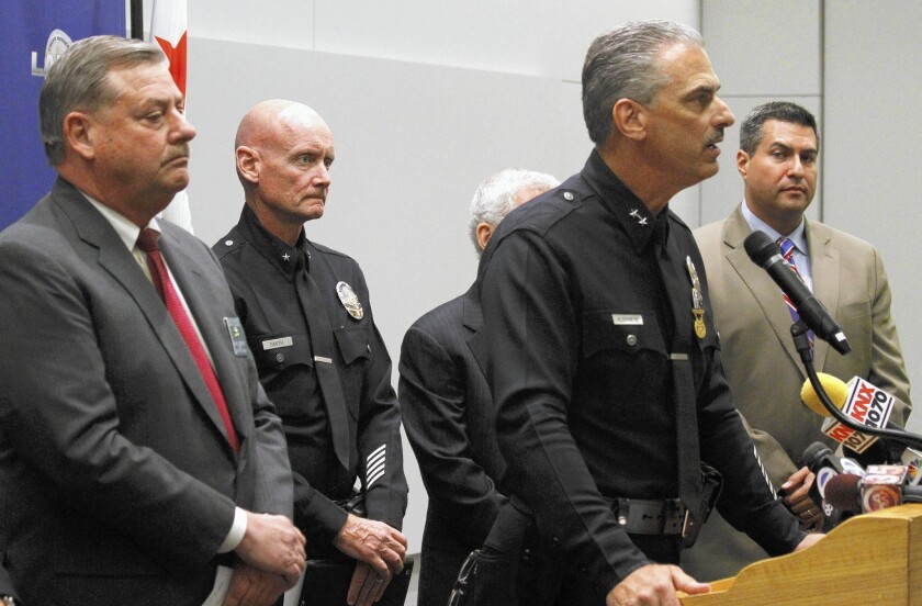 From left, sheriff's Chief of Detectives Bill McSweeney, Andrew Smith of the LAPD, Deputy Chief Kirk Albanese and City Councilman Felipe Fuentes hold a news conference about the arrest of a man in connection with four fatal shootings.