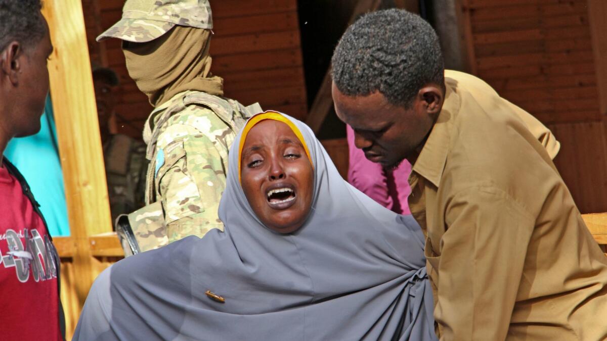 A mother grieves in Mogadishu, Somalia, for her daughter, who was shot in the head during a militant attack on a restaurant.