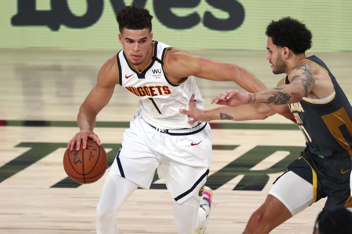 Nuggets forward Michael Porter Jr. (1) drives against Thunder forward Abdel Nader (11) during a game Aug. 3, 2020.