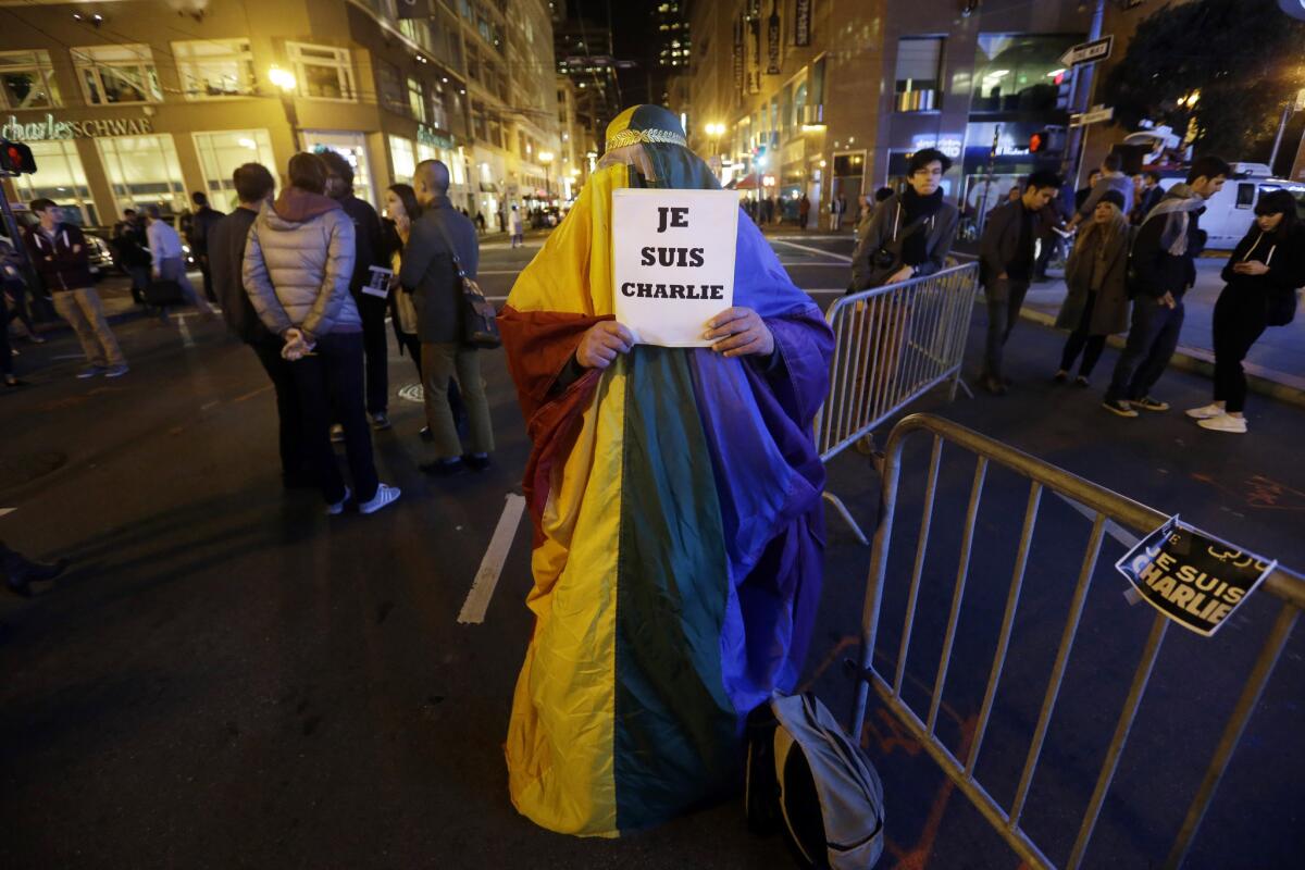 Michael Petrelis wears a rainbow colored outfit outside the French Consulate making a statement about tolerance at a gathering in solidarity with those killed in an attack at the Paris offices of the weekly newspaper Charlie Hebdo on Wednesday, Jan. 7, 2015, in San Francisco