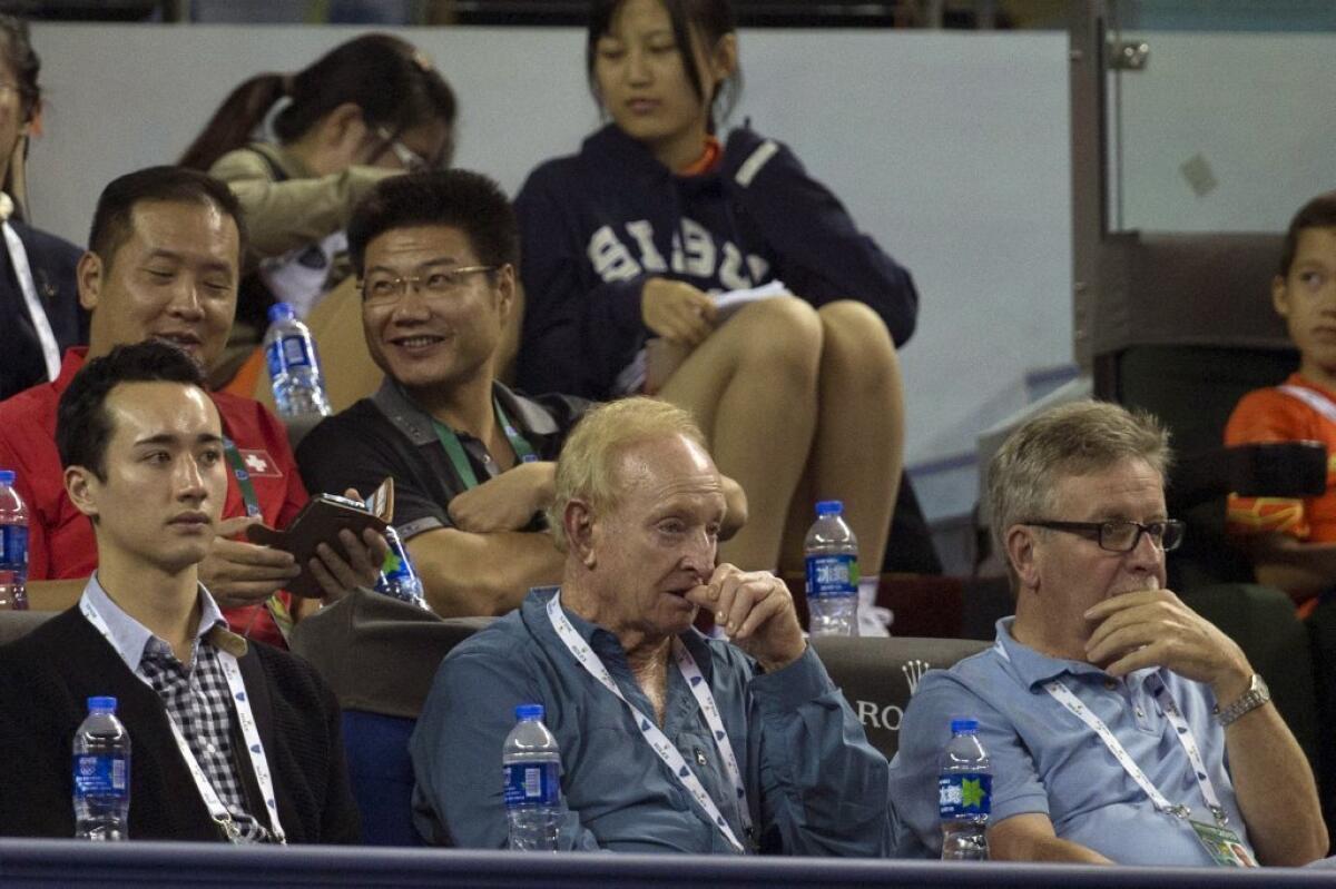 Rod Laver, front center, watches play at the Shanghai Masters.