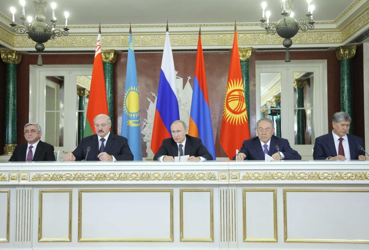 Russian President Vladimir Putin, center, is flanked from left to right by the presidents of Armenia, Belarus, Kazakhstan and Kyrgyzstan at the ceremonial creation of the Eurasian Economic Union on Tuesday.