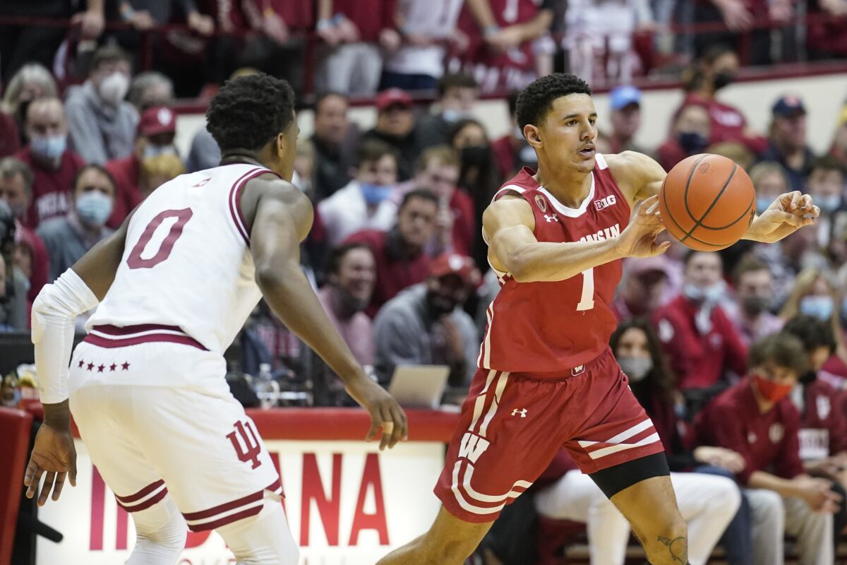 Wisconsin's Johnny Davis (1) passes against Indiana's Xavier Johnson (0) during the first half of an NCAA college basketball game, Tuesday, Feb. 15, 2022, in Bloomington, Ind. (AP Photo/Darron Cummings)
