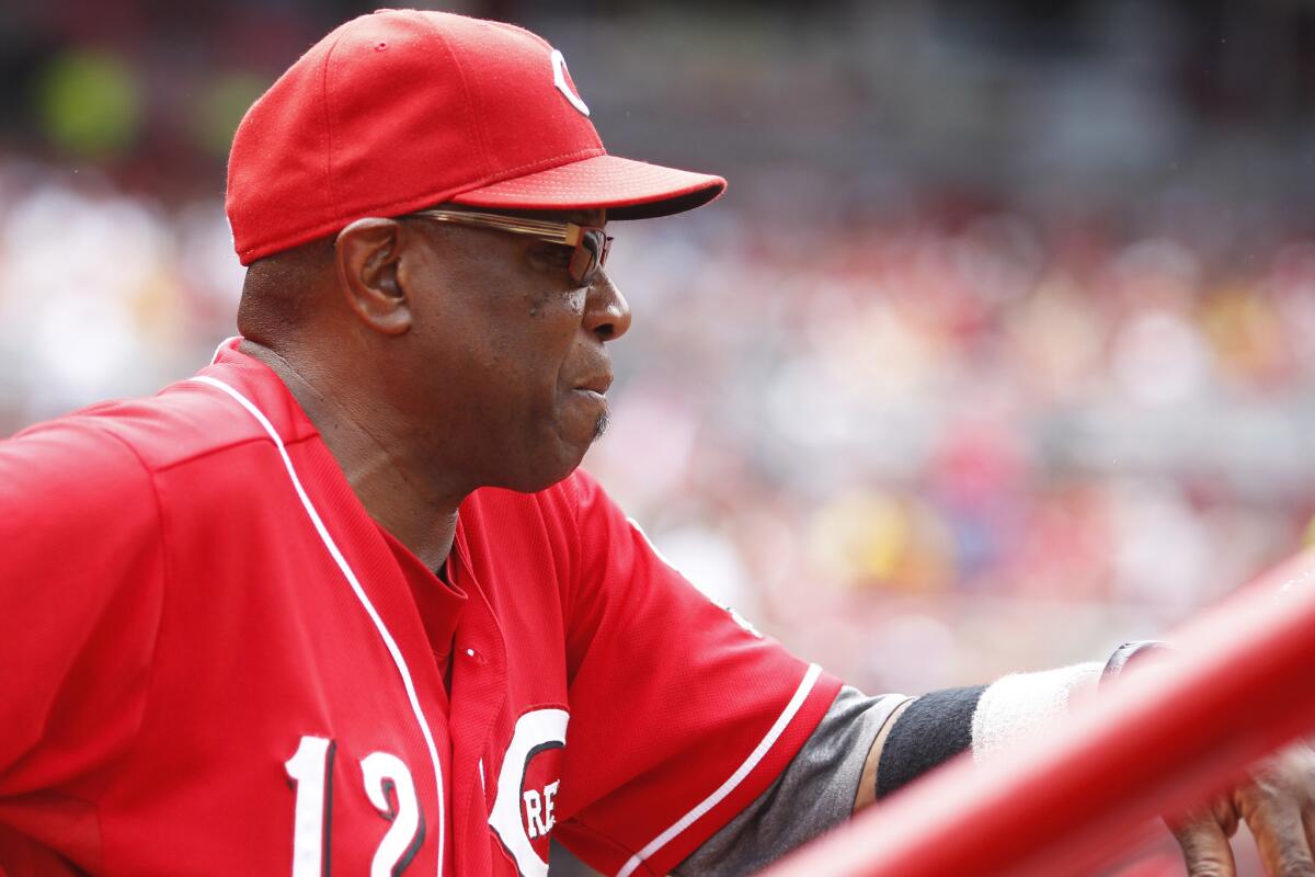 Reds Manager Dusty Baker, who was hospitalized in Chicago last week, said he's "feeling much better," but he won't return to the dugout for at least another week.