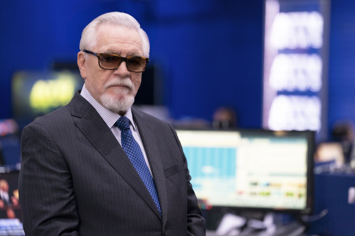A man in a newsroom in sunglasses