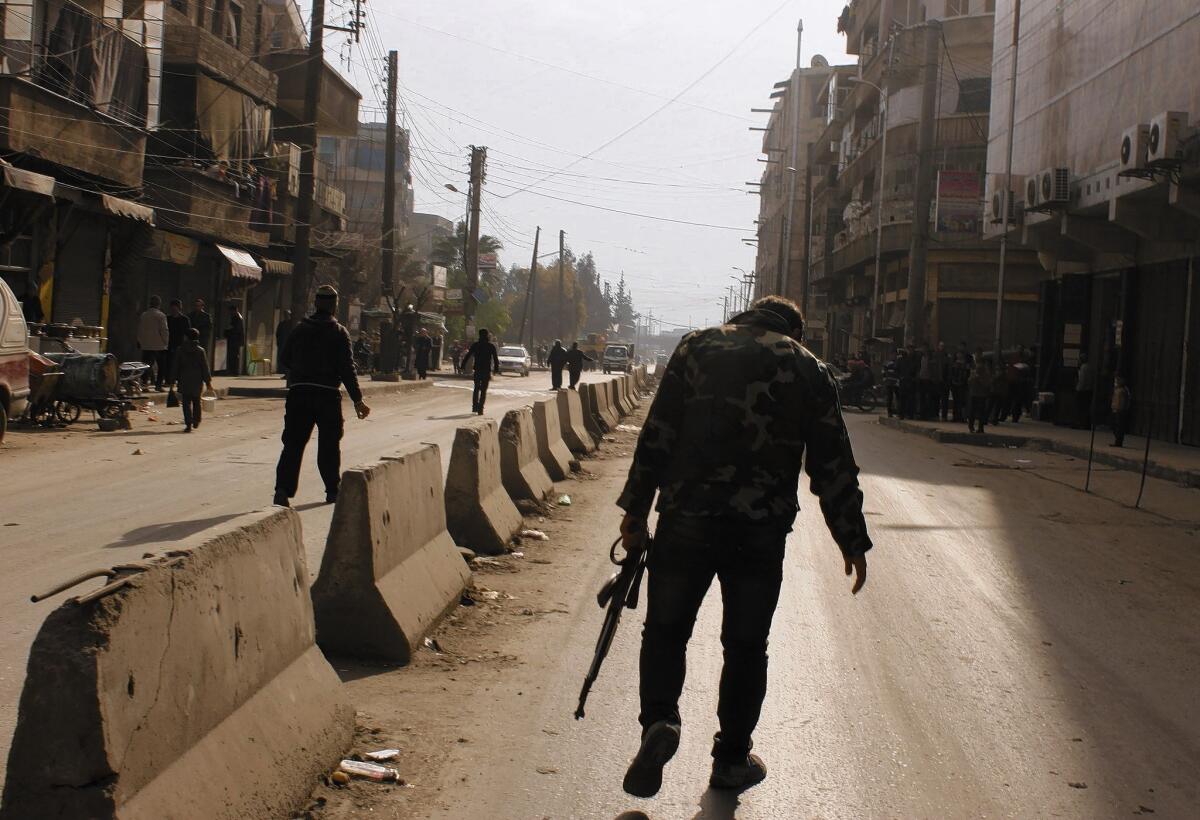 A rebel fighter walks in the northern Syrian city of Aleppo. Antigovernment rebels have been fighting to topple President Bashar Assad since early 2011.