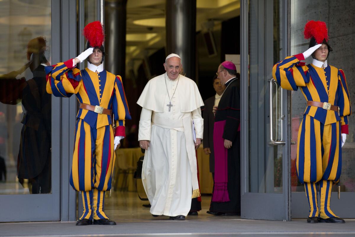 Pope Francis leaves at the end of an afternoon session of a two-week synod on family issues at the Vatican.