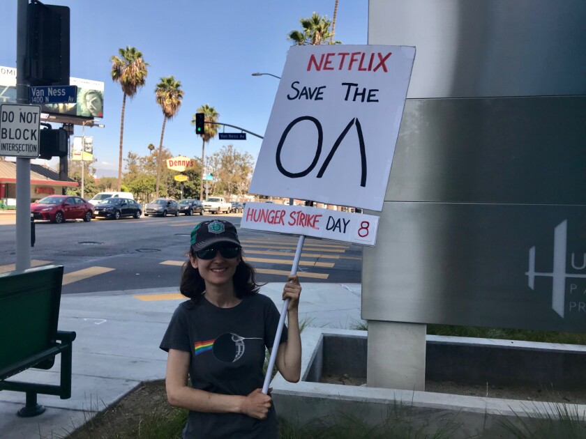 Emperial Young holds her “Save the OA” sign on the corner of Sunset Blvd. and Van Ness in Hollywood outside of the Netflix campus.