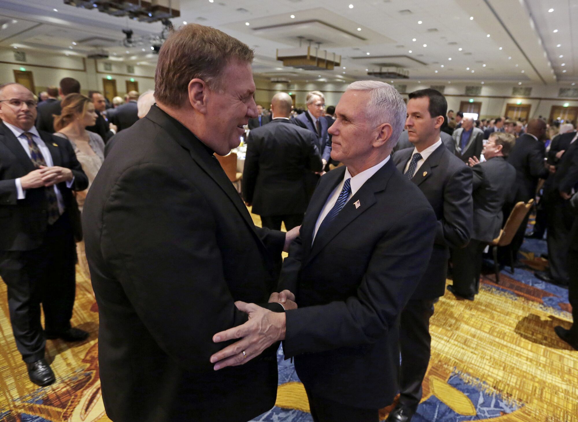 Mike Pence, right, and Cardinal Joseph W. Tobin greet each other in Indianapolis after the 2016 election.