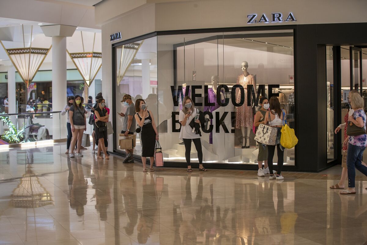 A long line of shoppers waits to enter Zara at South Coast Plaza.