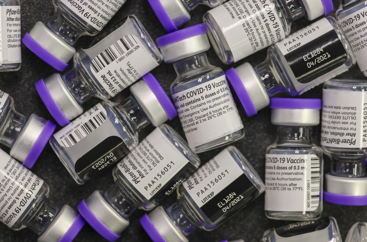 Vials filled with doses of the Pfizer COVID-19 vaccine are ready for use at the San Diego Fire-Rescue Training Facility.