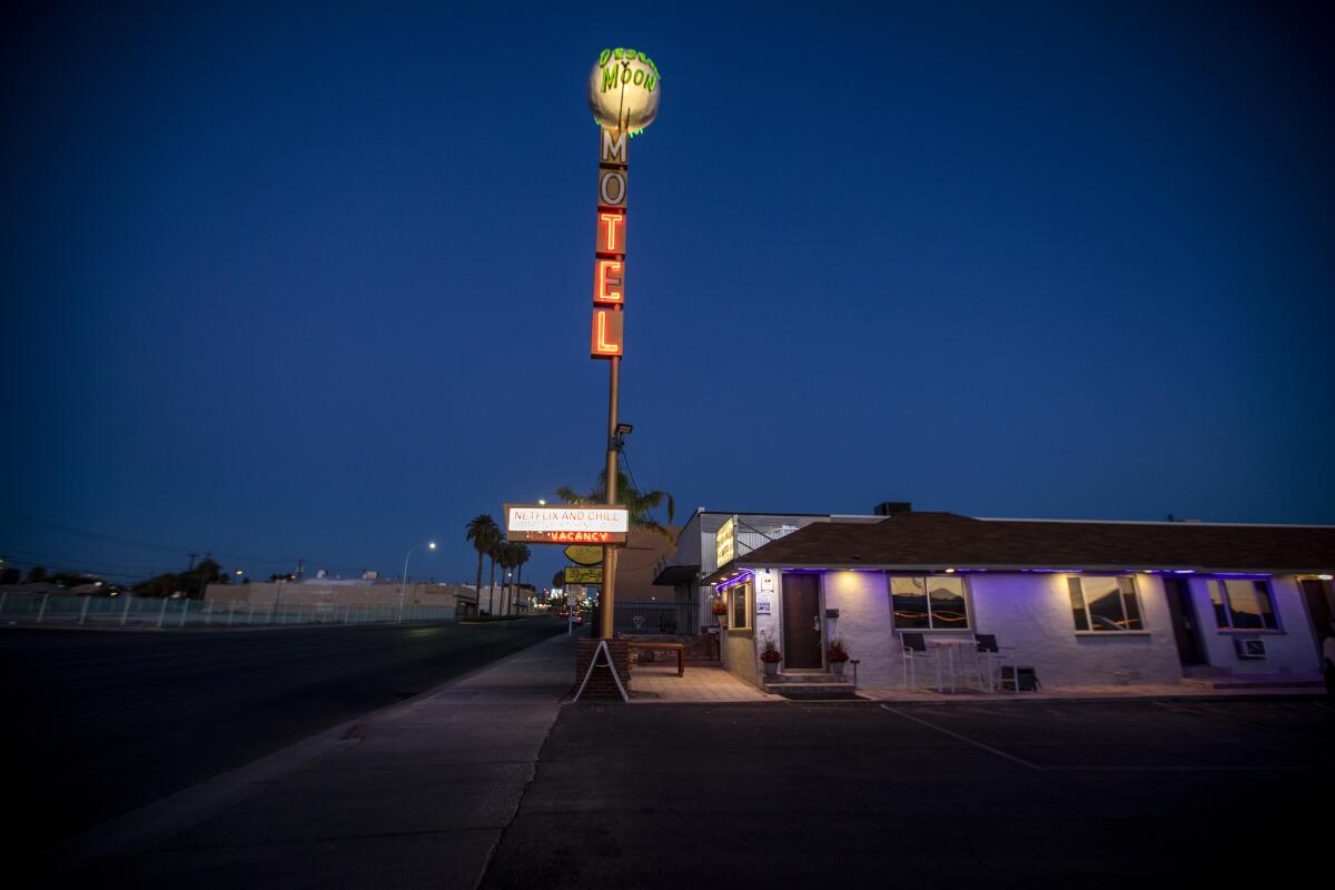 A neon sign reads "Motel" but the first two letters are dark.