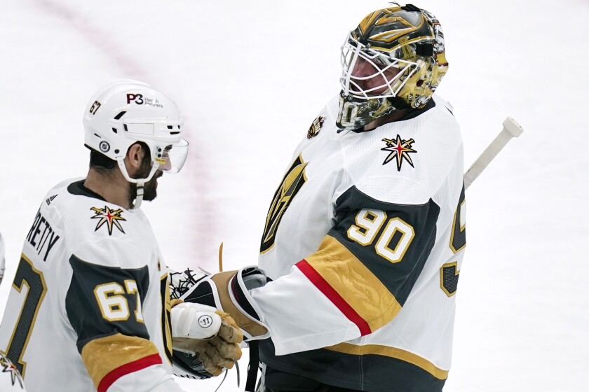 Vegas Golden Knights goaltender Robin Lehner (90) is congratulated by Max Pacioretty (67) after defeating the Boston Bruins 4-1 in an NHL hockey game, Tuesday, Dec. 14, 2021, in Boston. (AP Photo/Charles Krupa)