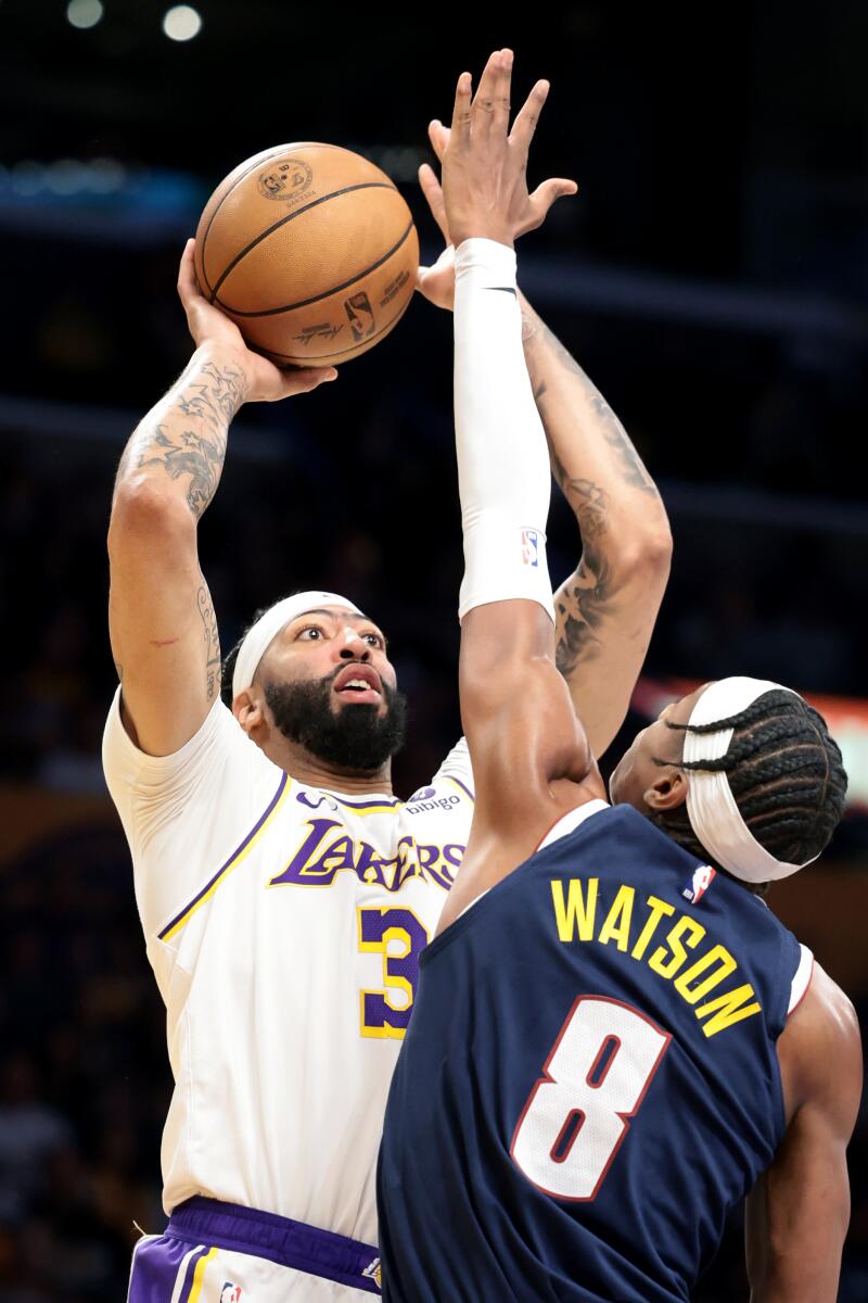 Lakers star Anthony Davis shoots over Denver's Peyton Watson in the first half of Game 4.