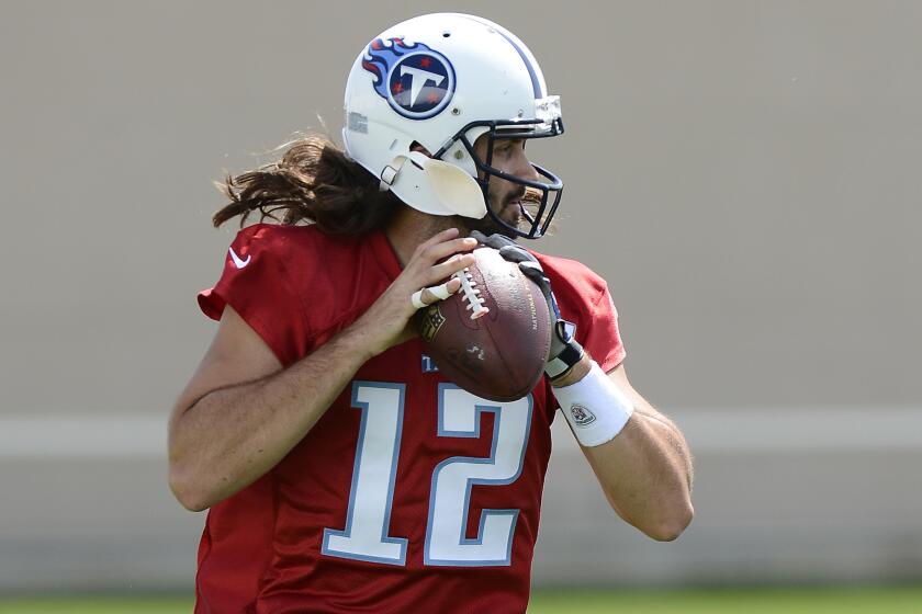 Tennessee Titans quarterback Charlie Whitehurst gives his new jersey number (12) a spin during a minicamp workout on April 29.