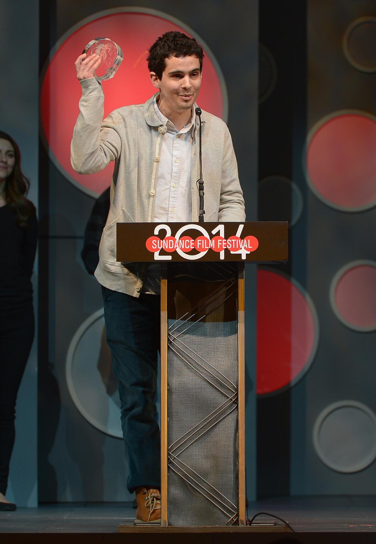 PARK CITY, UT - JANUARY 25: Director Damien Chazelle accepts the Audience Award: Dramatic presented by Acura for the film 'Whiplash' onstage at the Awards Night Ceremony at Basin Recreation Field House during the 2014 Sundance Film Festival on January 25, 2014 in Park City, Utah.