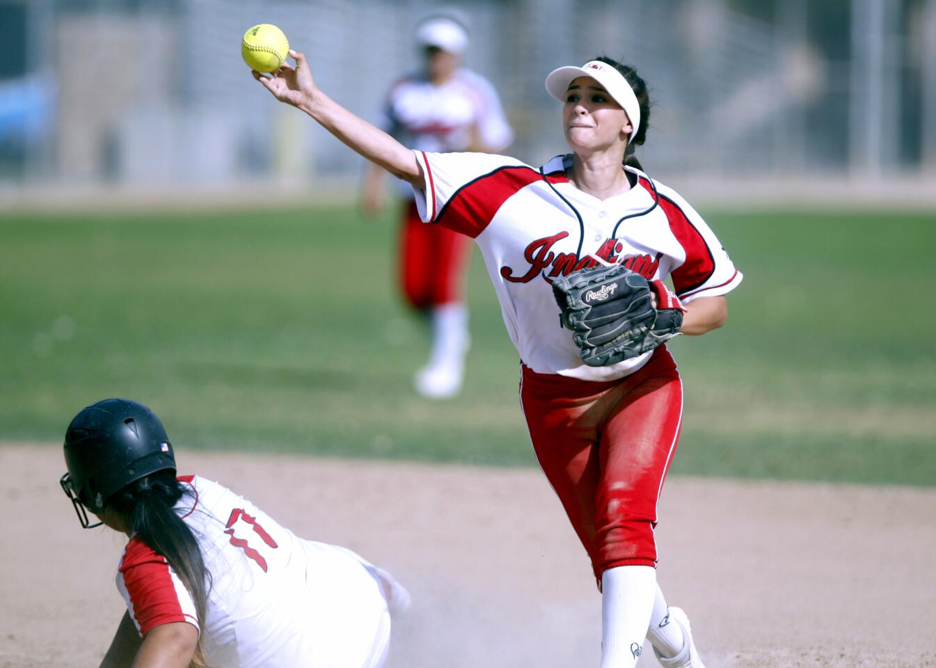 Burroughs High School softball player #23 Nikki Ricciardella gets #17 Mona Delarea out at second base and tries to turn a double play towards first base in home game vs. Glendale High School, at Olive Park in Burbank on Tuesday, April 25, 2017.