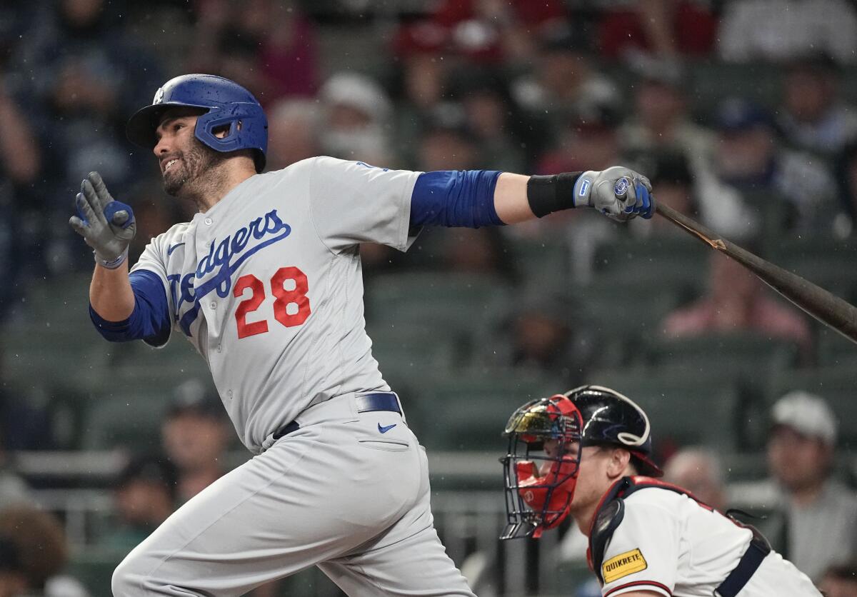Dodgers designated hitter J.D. Martinez (28) follows through on a single.