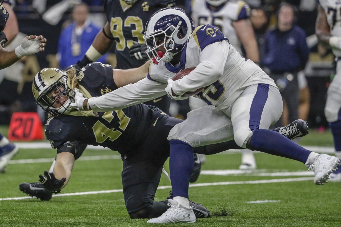 Rams running back CJ Anderson stiff arms New Orleans Saints linebacker Alex Anzalone for a short gain during a second half drive in the NFC Championship at the Superdome.