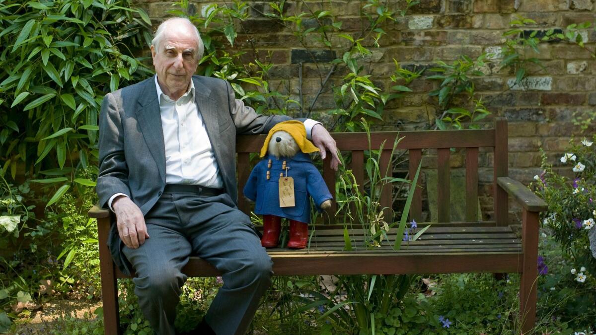 British author Michael Bond sits with Paddington Bear; publisher HarperCollins says Bond died June 27, 2017, at age 91.