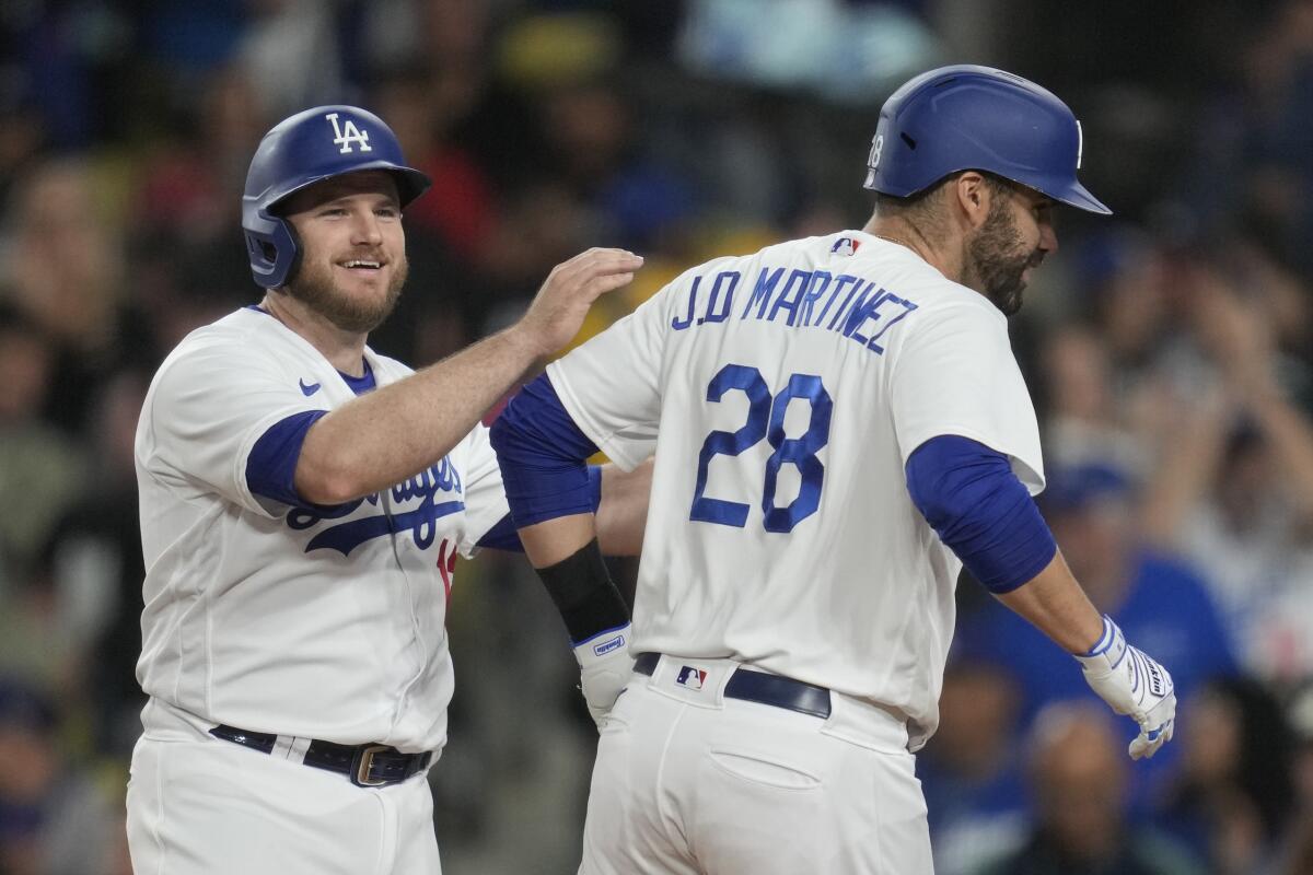 The Dodgers' Max Muncy celebrates with designated hitter J.D. Martinez