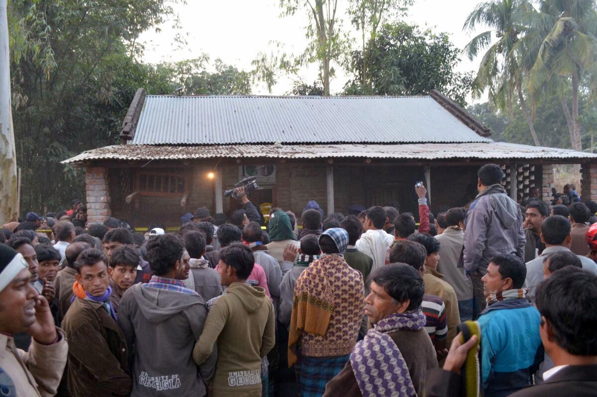 Onlookers gather following a suicide bomb blast at a Ahmadiyya mosque during Friday prayers in the Rajshahi region on Dec. 25.