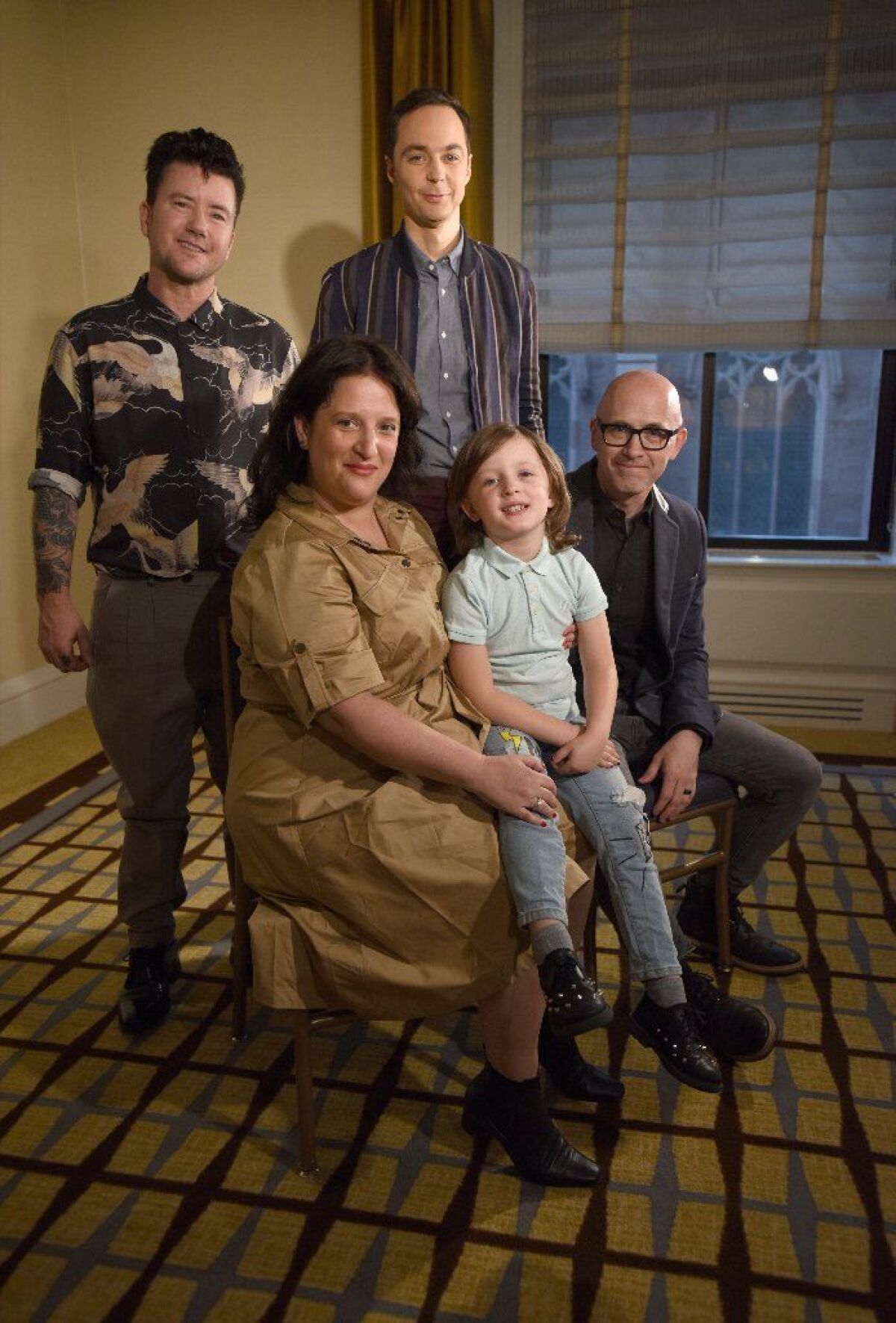 Producer and star Jim Parsons, back right, and director Silas Howard stand behind Leo James Davis and his parents, Danielle Super-Davis and Mike Davis.