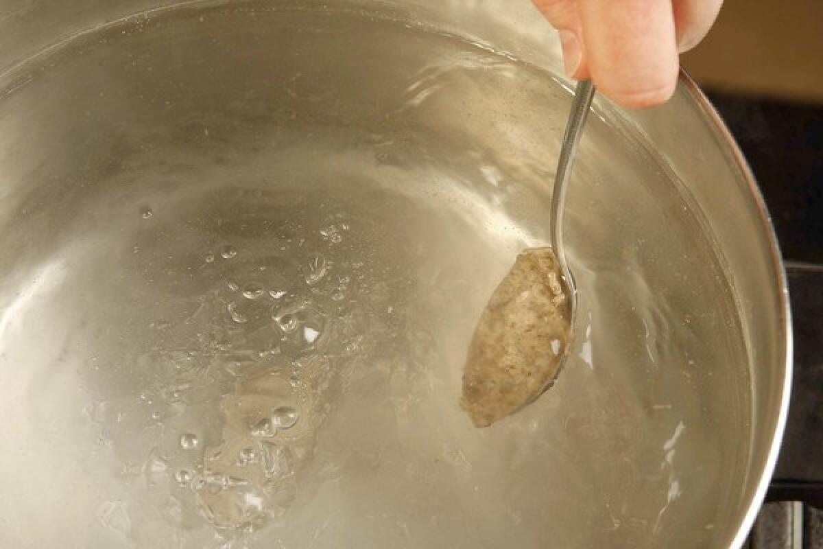 Wet the spoons in the poaching water so the quenelle batter does not stick.