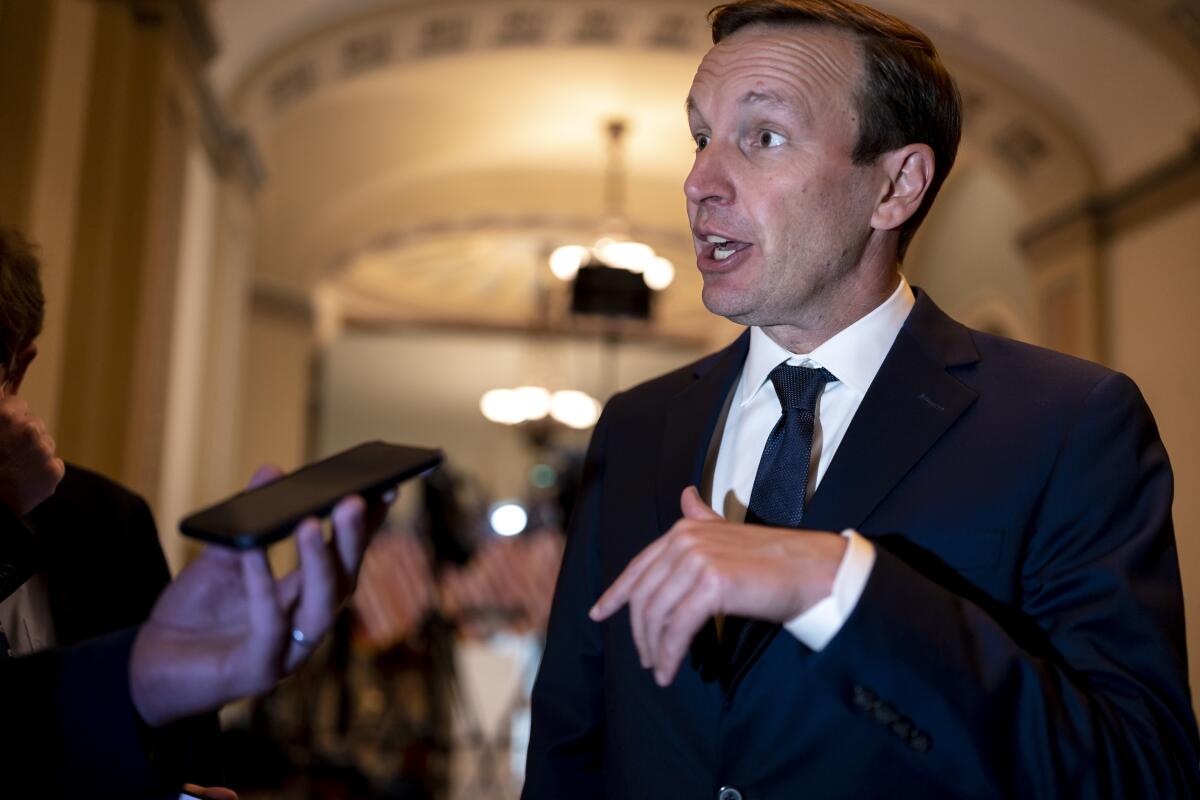 Connecticut Senator Chris Murphy pauses for questions from reporters