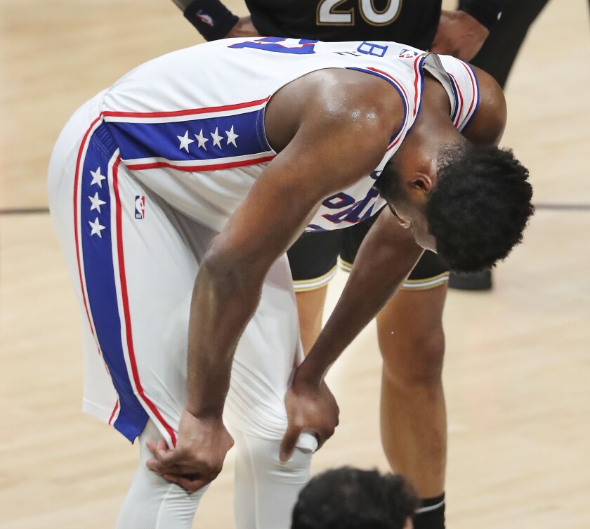 Philadelphia 76ers center Joel Embiid reacts after fouling Atlanta Hawks guard Trae Young in the final minutes of Game 4 of a second-round NBA basketball playoff series on Monday, June 14, 2021, in Atlanta. (Curtis Compton/Atlanta Journal-Constitution via AP)