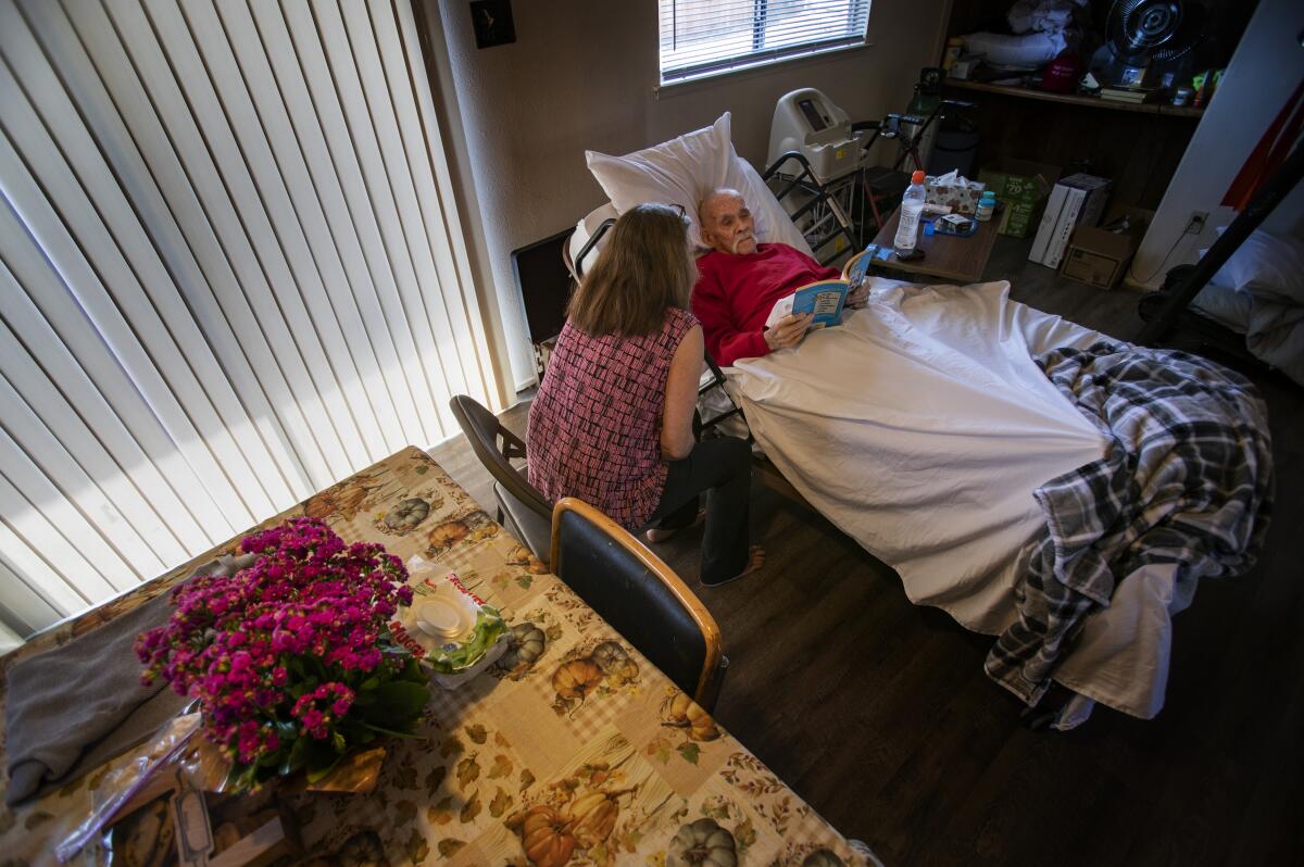 Debbie Erwig sits with her husband Bernie, 84, at their home. 