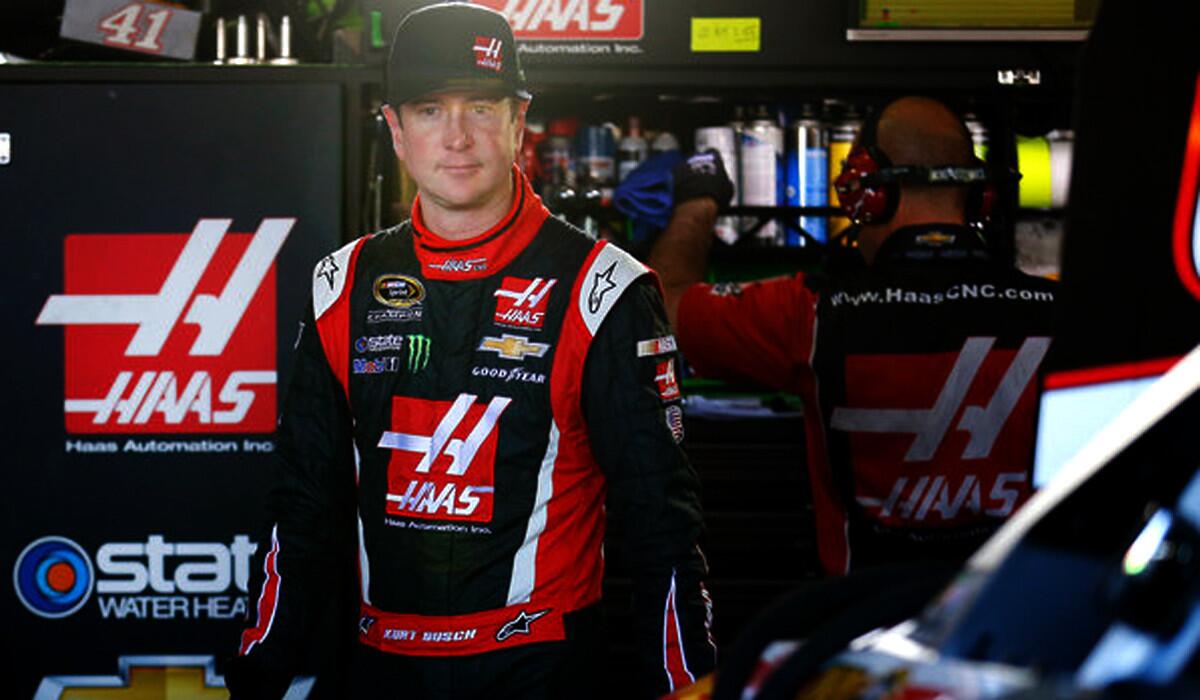 Kurt Busch stands in the garage area during Friday's practice for the NASCAR Sprint Cup Series race at Phoenix International Raceway.