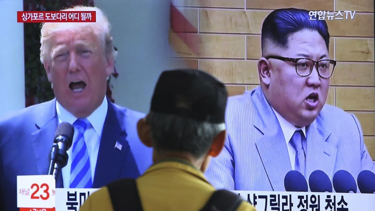 Images of President Trump and North Korean leader Kim Jong Un during a news program at the Seoul Railway Station.