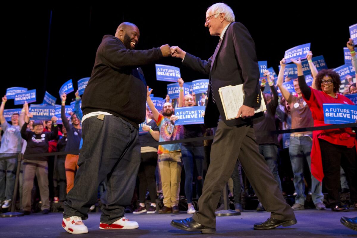 Rapper Killer Mike greets Democratic presidential candidate Bernie Sanders at a campaign rally in Columbia, S.C.