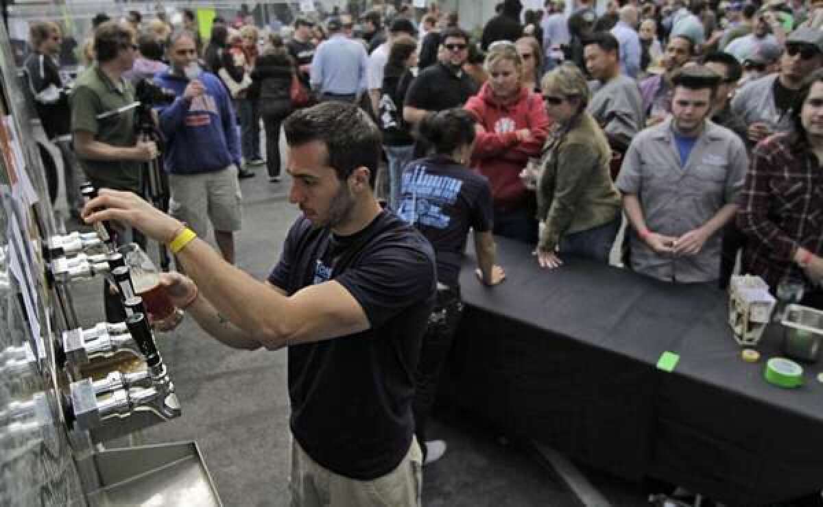 Michael Grossman of 38 Degrees Ale House & Grill pours a brew at a 2011 beer festival in Burbank.