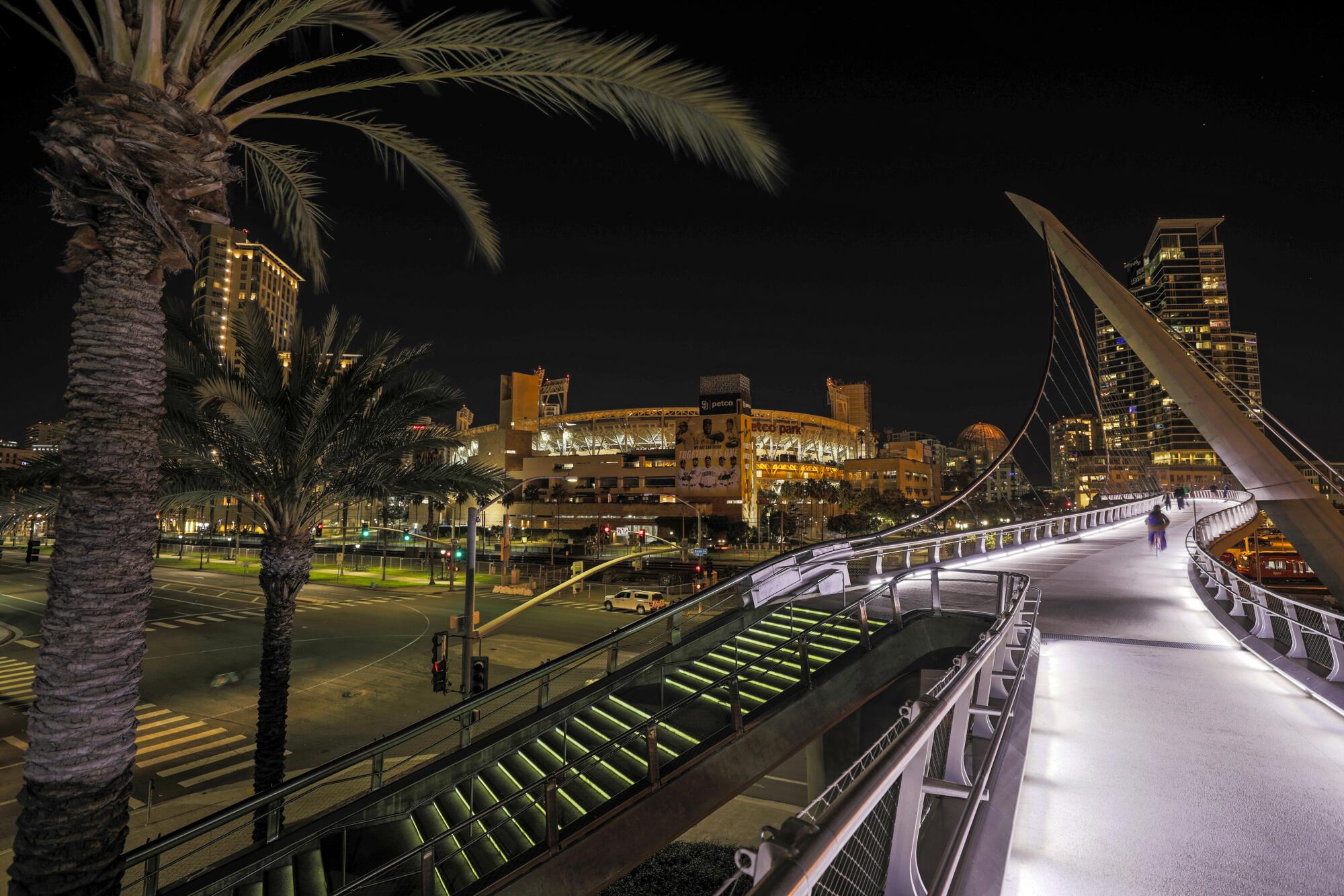 The Harbor Drive pedestrian bridge is seen lighted at night.