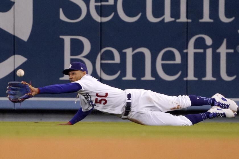 Los Angeles Dodgers right fielder Mookie Betts makes a catch on a ball hit by Arizona Diamondbacks' Carson Kelly