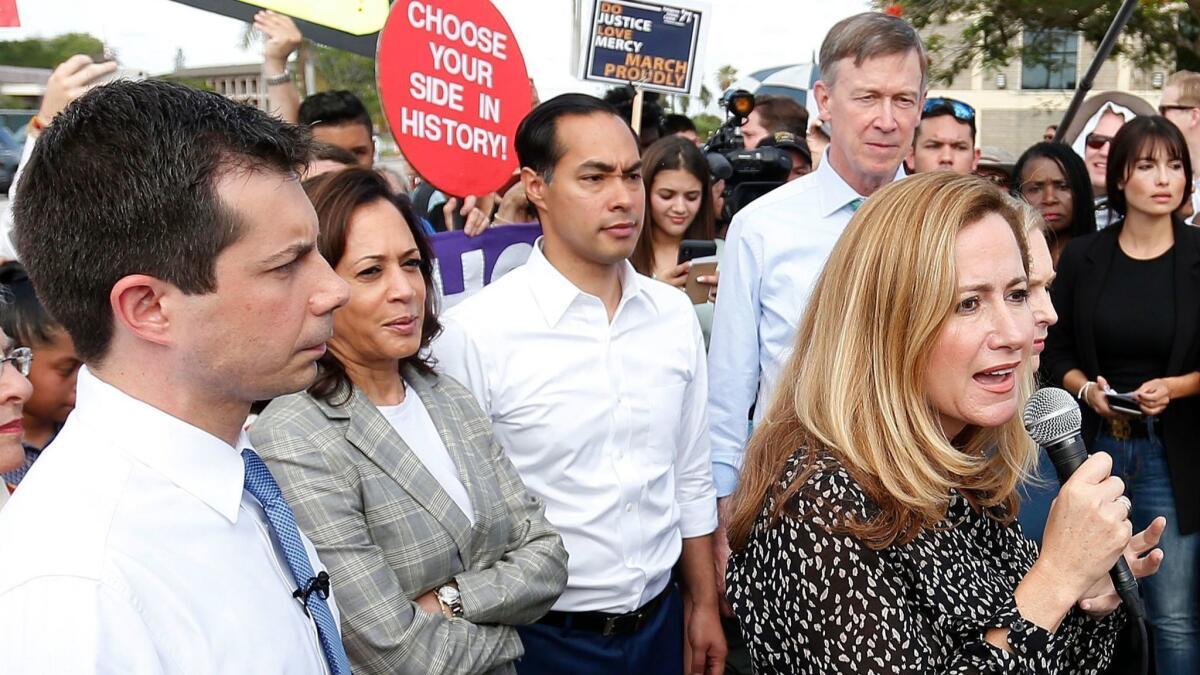 Rep. Debbie Mucarsel-Powell (D-Fla.) speaks outside a detention facility on Friday as Democratic presidential hopefuls Pete Buttigieg, from left, Kamala Harris, Julian Castro and John Hickenlooper stand behind her.