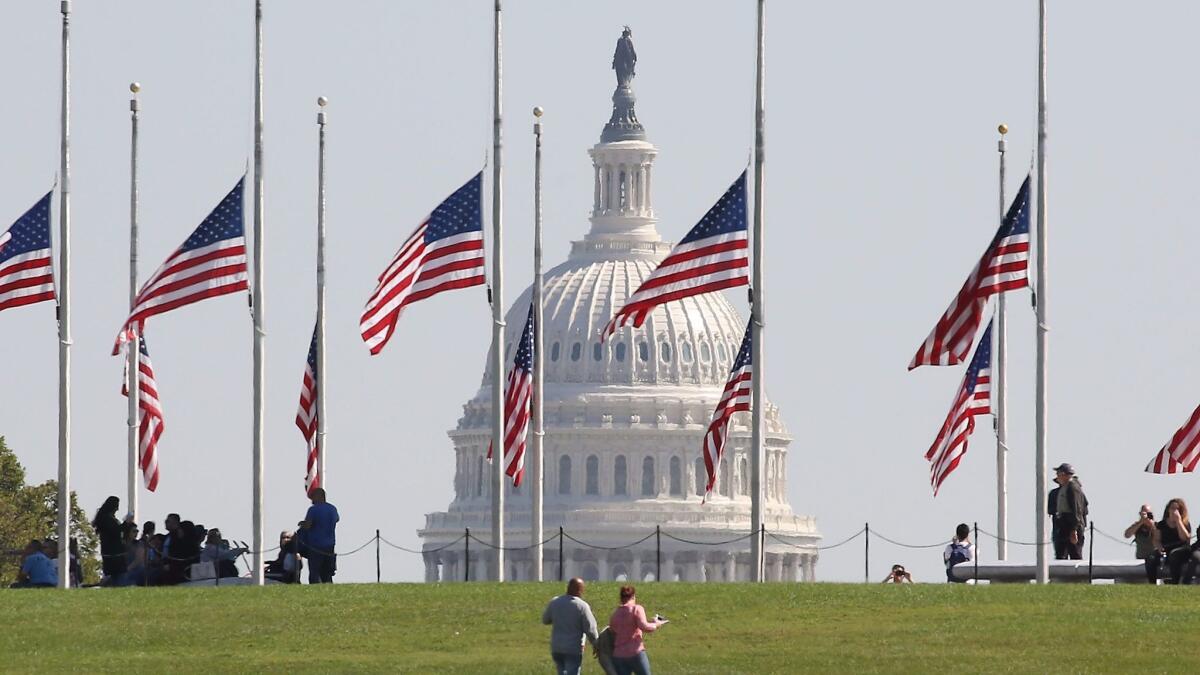 American flags at the Washington Monument fly at half-staff on Oct. 2, during a period of national mourning after the mass shooting in Las Vegas.