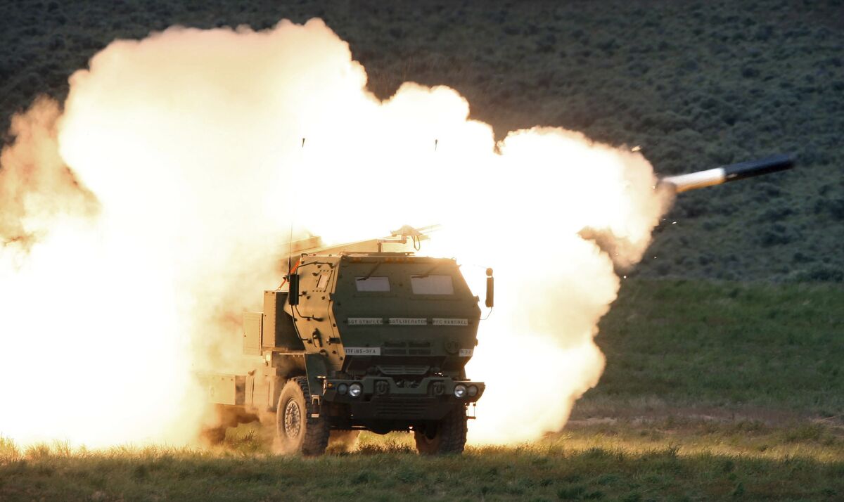 FILE - In this May 23, 2011, file photo a launch truck fires the High Mobility Artillery Rocket System (HIMARS) 